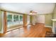 Open-concept layout featuring hardwood floors, and a view into a sun-lit living room at 409 Edgewood Ct, Lancaster, SC 29720