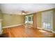 Spacious living room showcasing hardwood floors, a ceiling fan, and abundant natural light at 409 Edgewood Ct, Lancaster, SC 29720