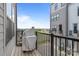 Balcony view with covered grill, black railings, and a glimpse of the neighborhood at 5006 Tiny Ln, Charlotte, NC 28203