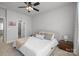 Bright bedroom featuring neutral decor, a cozy bed, and a ceiling fan at 5006 Tiny Ln, Charlotte, NC 28203