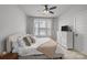 Bright bedroom featuring neutral decor, a cozy bed, and a dresser with a TV at 5006 Tiny Ln, Charlotte, NC 28203