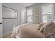 Bedroom featuring natural lighting from windows and a plush bed with decorative pillows at 5006 Tiny Ln, Charlotte, NC 28203