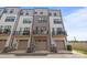 Modern townhome exterior with multiple stories, private balconies, and individual garage parking at 5006 Tiny Ln, Charlotte, NC 28203