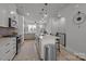 Modern kitchen with white cabinets, stainless steel appliances, and a spacious center island at 5006 Tiny Ln, Charlotte, NC 28203