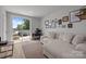 Bright living area with walkout to patio and views, stylish furniture and desk space at 5006 Tiny Ln, Charlotte, NC 28203