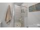 Walk-in shower featuring glass enclosure and built-in bench at 5006 Tiny Ln, Charlotte, NC 28203