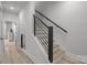 Modern staircase with black metal railing and wood treads, leading to upper levels at 5006 Tiny Ln, Charlotte, NC 28203