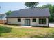 View of the home's backyard with sliding glass doors and new, dark roof at 520 E Main St, Dallas, NC 28034