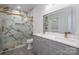 Modern bathroom with a double sink vanity, decorative lighting, and a glass enclosed shower at 520 E Main St, Dallas, NC 28034