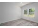 Bright bedroom with luxury vinyl flooring, neutral paint, and two windows at 520 E Main St, Dallas, NC 28034