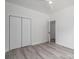 Bright bedroom with luxury vinyl flooring and a closet that is conveniently accessible at 520 E Main St, Dallas, NC 28034