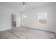 Bright bedroom features luxury vinyl flooring, neutral paint, and two windows at 520 E Main St, Dallas, NC 28034