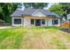 Inviting home showcasing a well-manicured front lawn and a covered porch at 520 E Main St, Dallas, NC 28034
