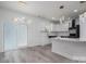 Modern kitchen featuring white cabinets, stylish light fixtures, stainless appliances, and subway tile backsplash at 520 E Main St, Dallas, NC 28034