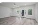 Bright living room featuring fresh paint, new flooring, and a stylish ceiling fan at 520 E Main St, Dallas, NC 28034