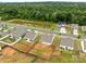 Aerial view showcases pond and surrounding houses with neatly landscaped yards and lush green trees at 5314 Upton Pl, Charlotte, NC 28215