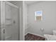 Bright bathroom boasts a glass shower, wire shelving, and a toilet, all lit by a window at 5314 Upton Pl, Charlotte, NC 28215
