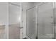 Modern bathroom featuring a glass enclosed shower with granite countertops and a view into the bedroom at 5314 Upton Pl, Charlotte, NC 28215