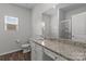 Modern bathroom featuring a granite countertop, white cabinets, and a large mirror at 5314 Upton Pl, Charlotte, NC 28215