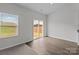 Bright bedroom with plush carpeting and a sliding glass door leading to the backyard at 5314 Upton Pl, Charlotte, NC 28215