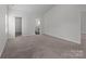 A carpeted room offers multiple entryways and ample lighting for a bright and airy space at 5314 Upton Pl, Charlotte, NC 28215