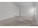 A carpeted bedroom boasts a modern design with neutral colors and natural light from a window at 5314 Upton Pl, Charlotte, NC 28215