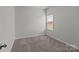 The carpeted bedroom offers natural light and neutral tones, creating a versatile and inviting space at 5314 Upton Pl, Charlotte, NC 28215