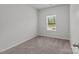 Bedroom with neutral walls, carpeted floors, and a window with blinds at 5314 Upton Pl, Charlotte, NC 28215