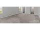 Carpeted bedroom featuring closet, complemented by natural light streaming in through the windows at 5314 Upton Pl, Charlotte, NC 28215