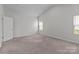 This neutral bedroom is carpeted, has one window for natural light, and has an adjoining closet at 5314 Upton Pl, Charlotte, NC 28215