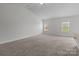 Bonus room with vaulted ceilings and two windows for natural light at 5314 Upton Pl, Charlotte, NC 28215