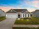 Charming single-story home with manicured lawn, attached garage, and neutral-toned siding at 5314 Upton Pl, Charlotte, NC 28215
