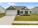 Beautiful home featuring a two-car garage, manicured lawn, and detailed landscaping at 5314 Upton Pl, Charlotte, NC 28215