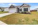 Traditional home front exterior featuring a two-car garage, well-kept lawn, and minimal landscaping at 5314 Upton Pl, Charlotte, NC 28215