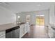 Bright, open kitchen area with stainless steel appliances, granite countertops, and a view of the backyard at 5314 Upton Pl, Charlotte, NC 28215