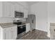 Well-equipped kitchen featuring stainless steel appliances, granite countertops, and white cabinets at 5314 Upton Pl, Charlotte, NC 28215