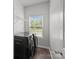 Modern laundry room with stainless steel washer and dryer at 5314 Upton Pl, Charlotte, NC 28215