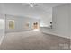 Bright, open-concept living room with plush carpeting, complemented by an eat-in kitchen at 5314 Upton Pl, Charlotte, NC 28215