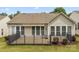 Home's backyard features a fenced in patio with awning and view of lawn at 56119 Finches Ct, Indian Land, SC 29707