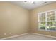 This bedroom features neutral walls, carpet, a ceiling fan, and a window at 56119 Finches Ct, Indian Land, SC 29707