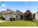 Charming single-story home featuring a two-car garage and a well-manicured lawn and garden at 56119 Finches Ct, Indian Land, SC 29707