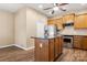A modern kitchen island features wood cabinets, sleek countertops, and stainless steel appliances at 56119 Finches Ct, Indian Land, SC 29707