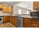 A modern kitchen showcasing wood cabinets, sleek countertops, and stainless steel appliances for culinary delight at 56119 Finches Ct, Indian Land, SC 29707