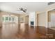 Spacious living room with hardwood floors, fireplace, ceiling fan, and large windows at 56119 Finches Ct, Indian Land, SC 29707
