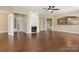 Spacious living room with hardwood floors, fireplace, ceiling fan, and large windows at 56119 Finches Ct, Indian Land, SC 29707