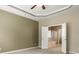 Spacious main bedroom with tray ceilings, a ceiling fan, and an attached bathroom with a soaking tub at 56119 Finches Ct, Indian Land, SC 29707