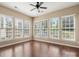 Bright and airy sunroom featuring hardwood floors and walls of windows, creating a warm and inviting space at 56119 Finches Ct, Indian Land, SC 29707