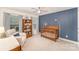 Charming Bedroom featuring a crib, a bookcase filled with books and toys, and large windows at 635 R L Stowe Rd, Belmont, NC 28012