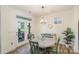 Charming dining area with a round table, green chairs, and natural light from the French doors at 635 R L Stowe Rd, Belmont, NC 28012