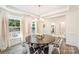 Bright dining room featuring wood floors, wainscoting, large windows, and a round dining table with chairs at 635 R L Stowe Rd, Belmont, NC 28012